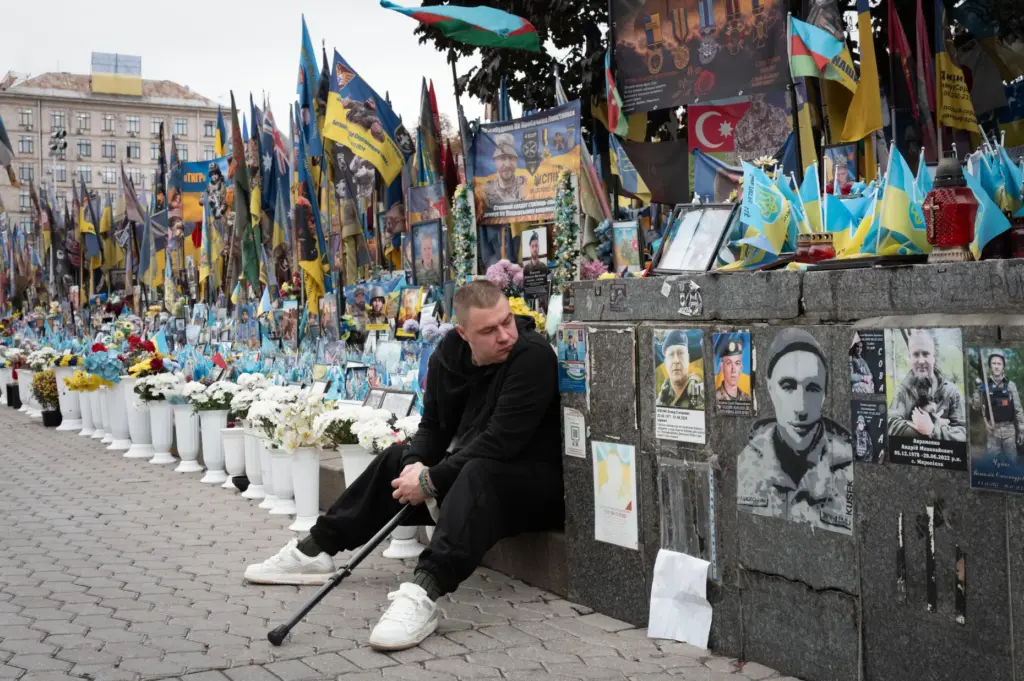 A veteran pays his respects at a makeshift memorial to...