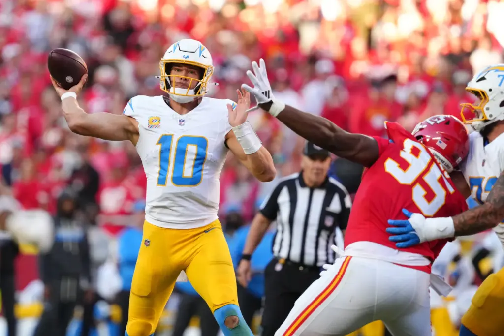 Chargers quarterback Justin Herbert (10) throws a pass under pressure...