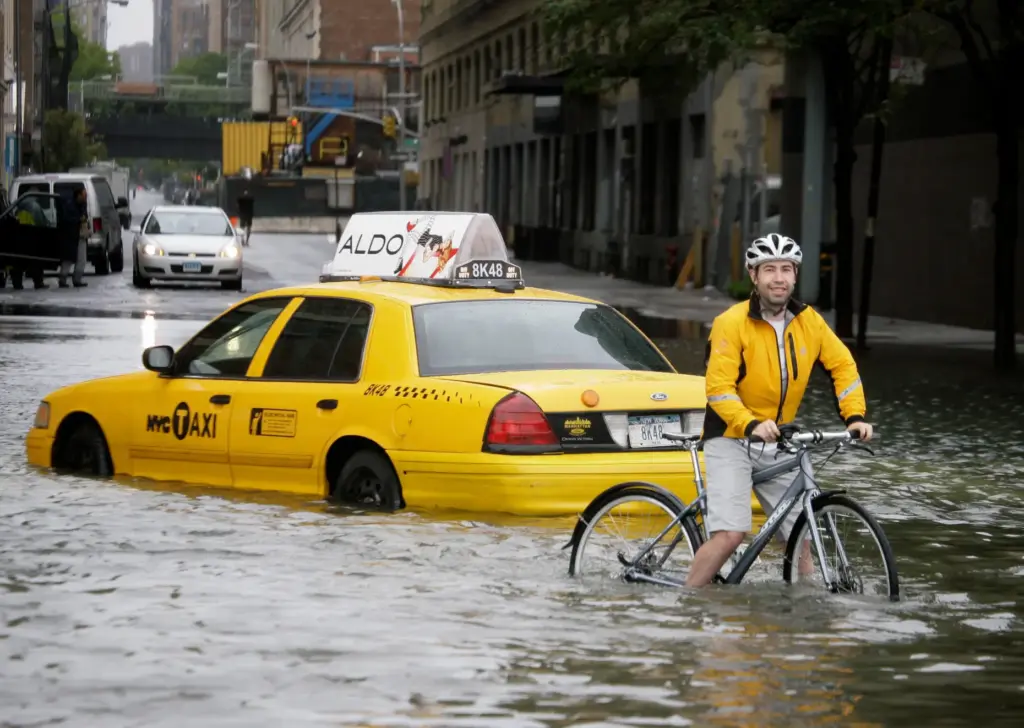 FILE – A bicyclist making his way past a stranded...