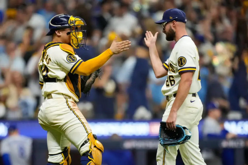 Milwaukee Brewers relief pitcher Aaron Ashby, right, greets catcher William...
