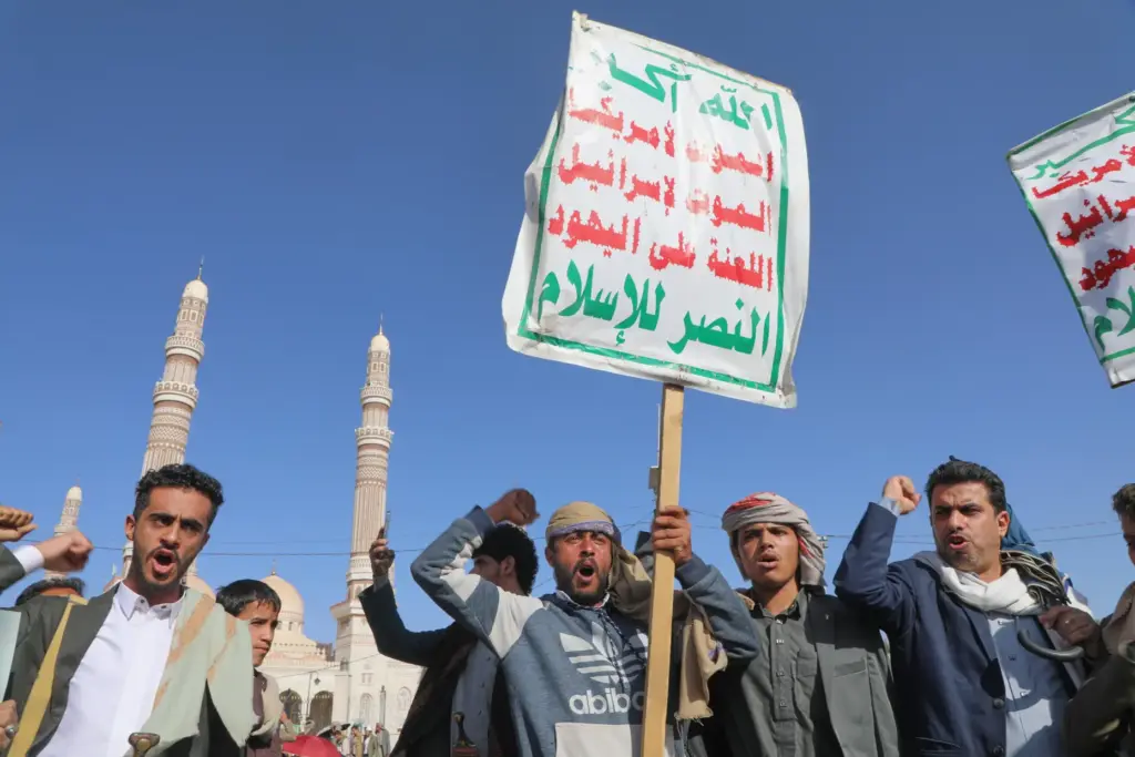 Supporters of Yemen’s Houthi rebels shout slogans during a rally...