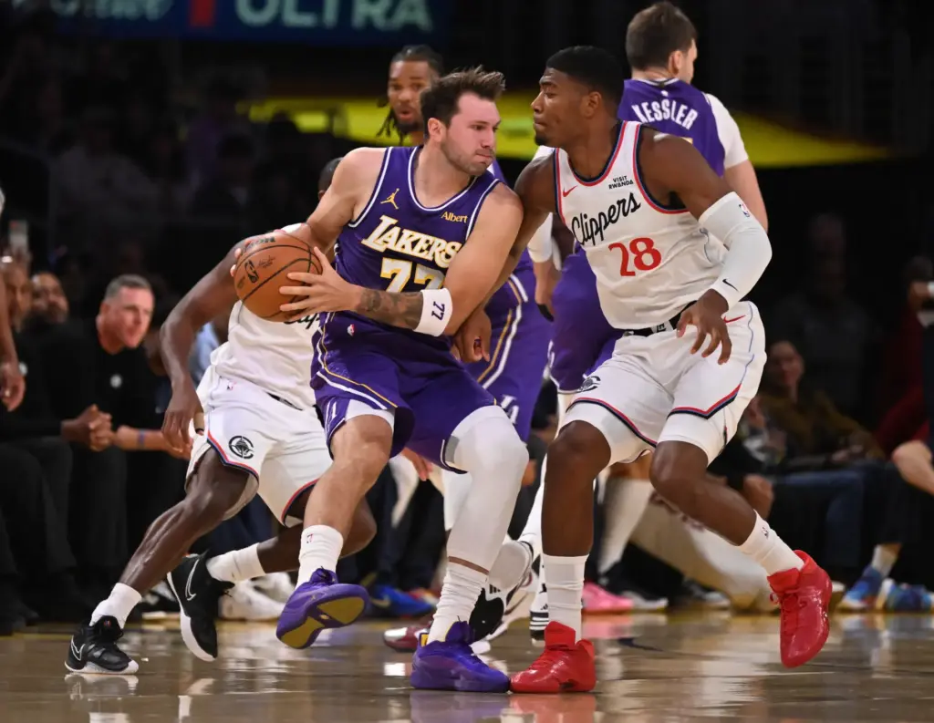 Lakers star Luka Doncic handles the ball as Clippers forward...