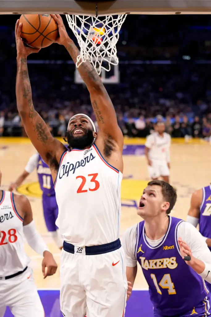 Clippers forward/center Isaiah Jackson, left, shoots as Lakers center Walker...