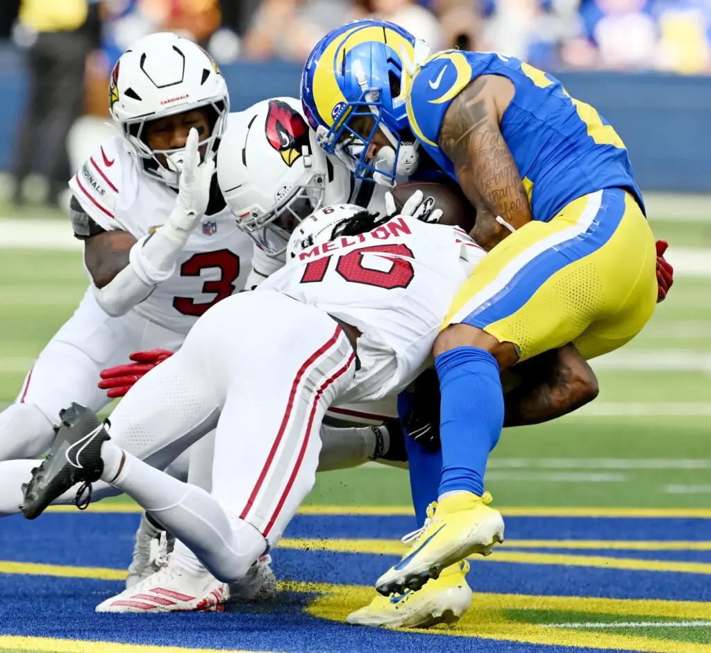 Arizona Cardinals cornerback Max Melton (16) hits Rams running back...