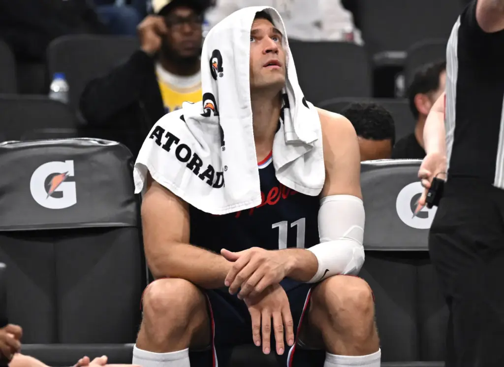 Clippers center Brook Lopez sits on the bench late in...