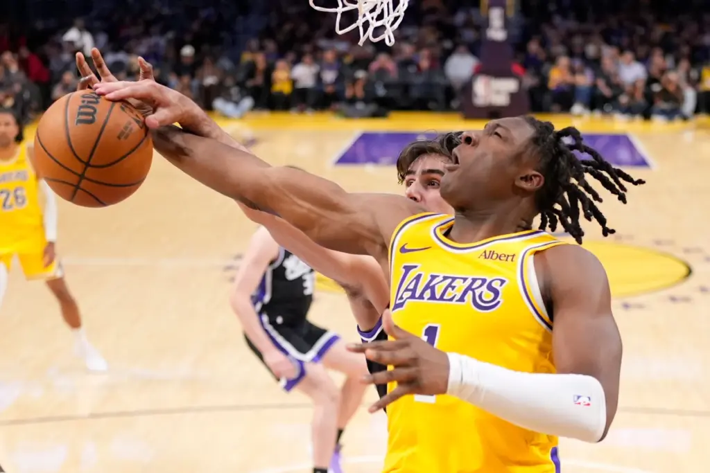 Lakers forward Adou Thiero, front, and Sacramento Kings center Maxime...