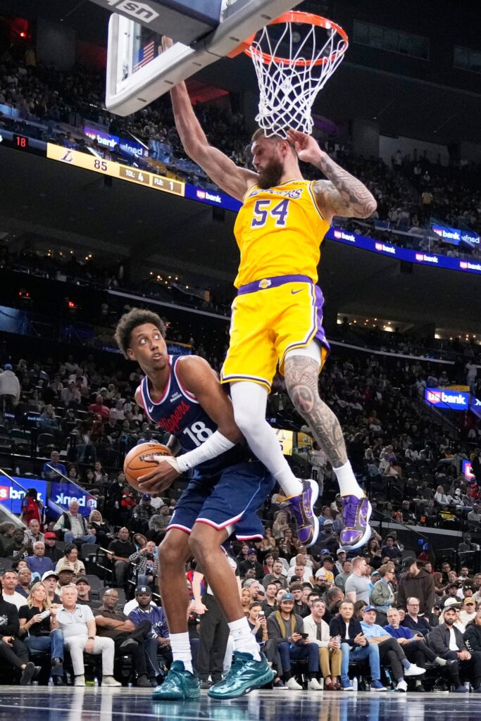 Clippers rookie forward Baba Miller, left, tries to shoot as...