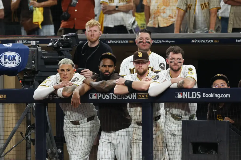 San Diego Padres players watch from the dugout during the...