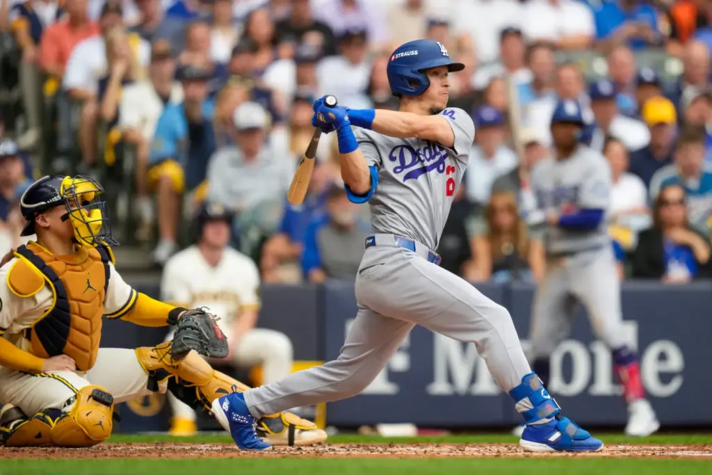 The Dodgers’ Tommy Edman hits a single during the third...