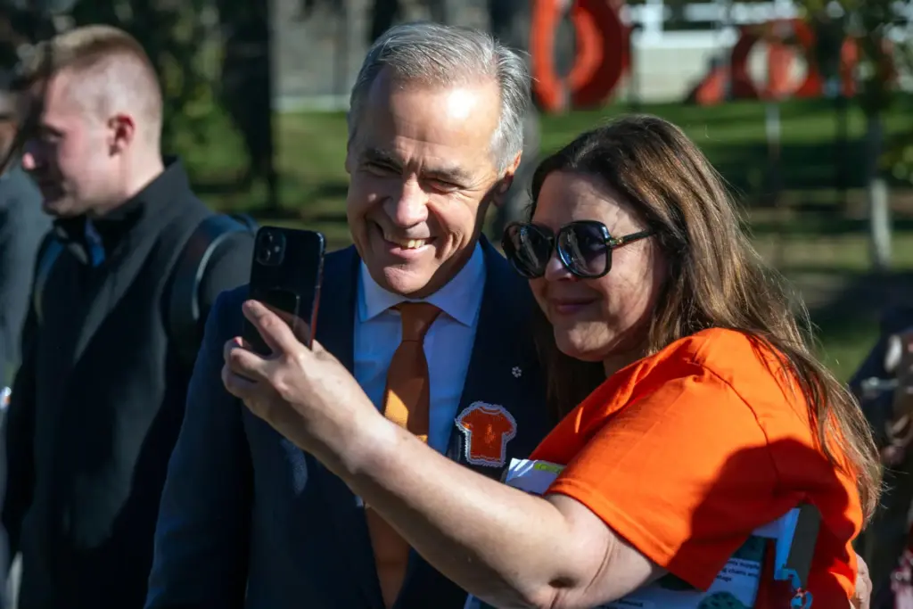 Canada Prime Minister Mark Carney, left, poses at the National...
