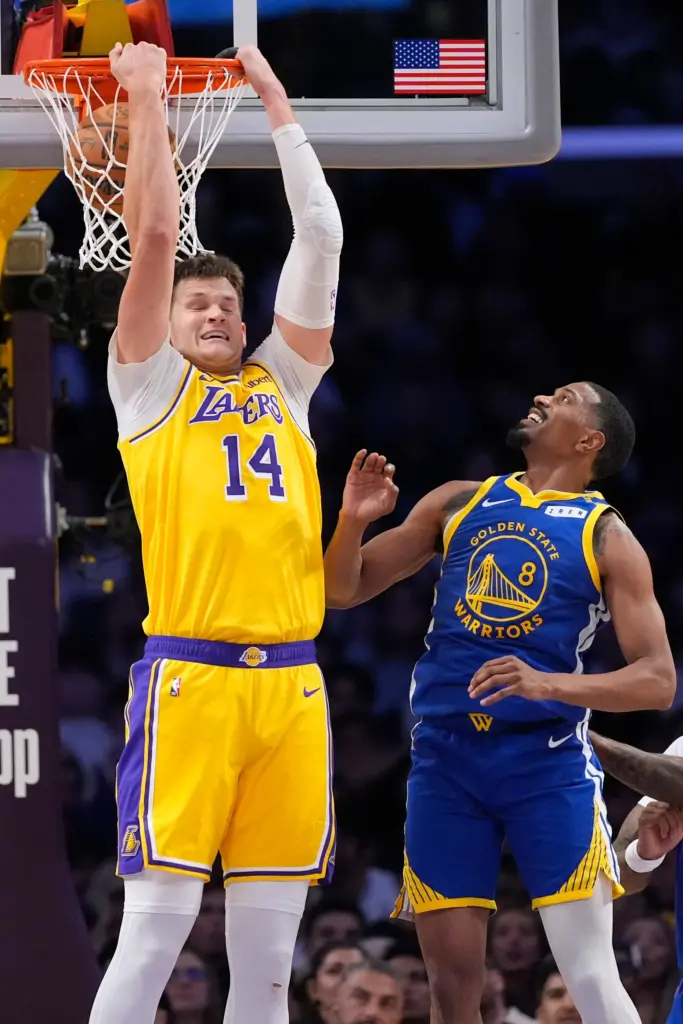 Lakers center Walker Kessler, left, dunks as Golden State Warriors...