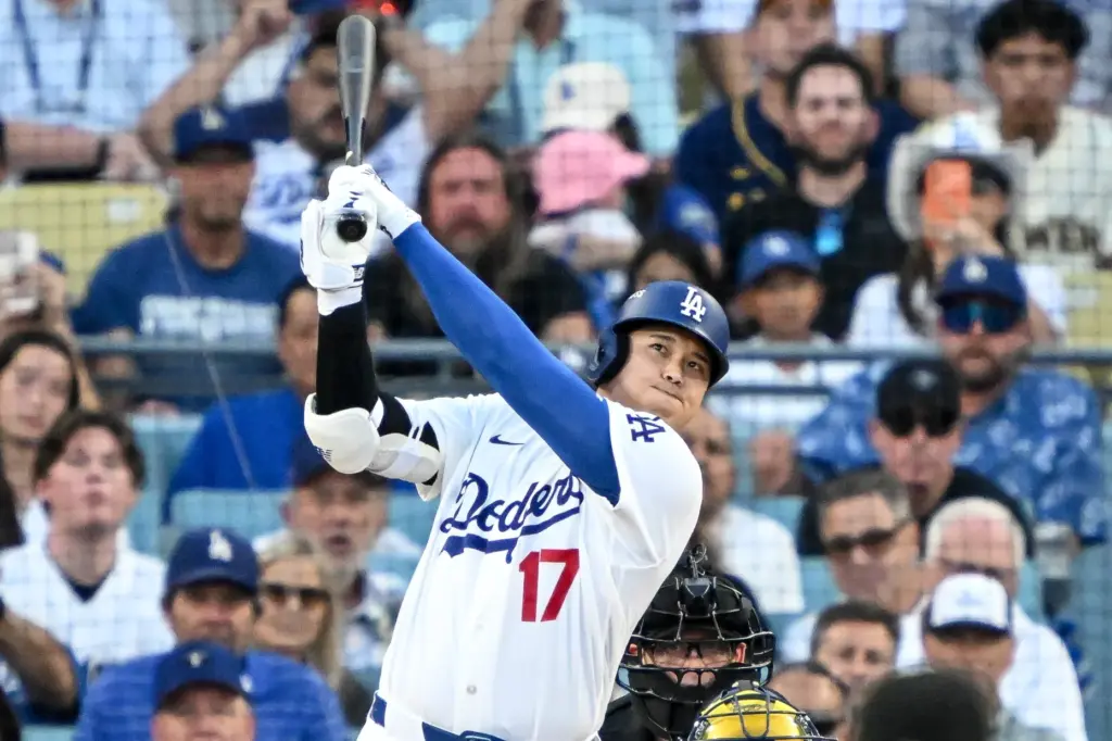 Dodgers star Shohei Ohtani watches the flight of his three-run...