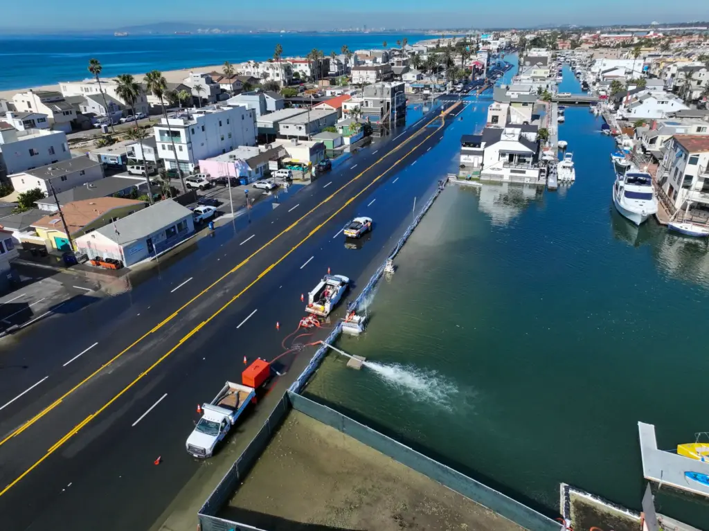 Workers pump water in to Huntington Harbour as sea water...