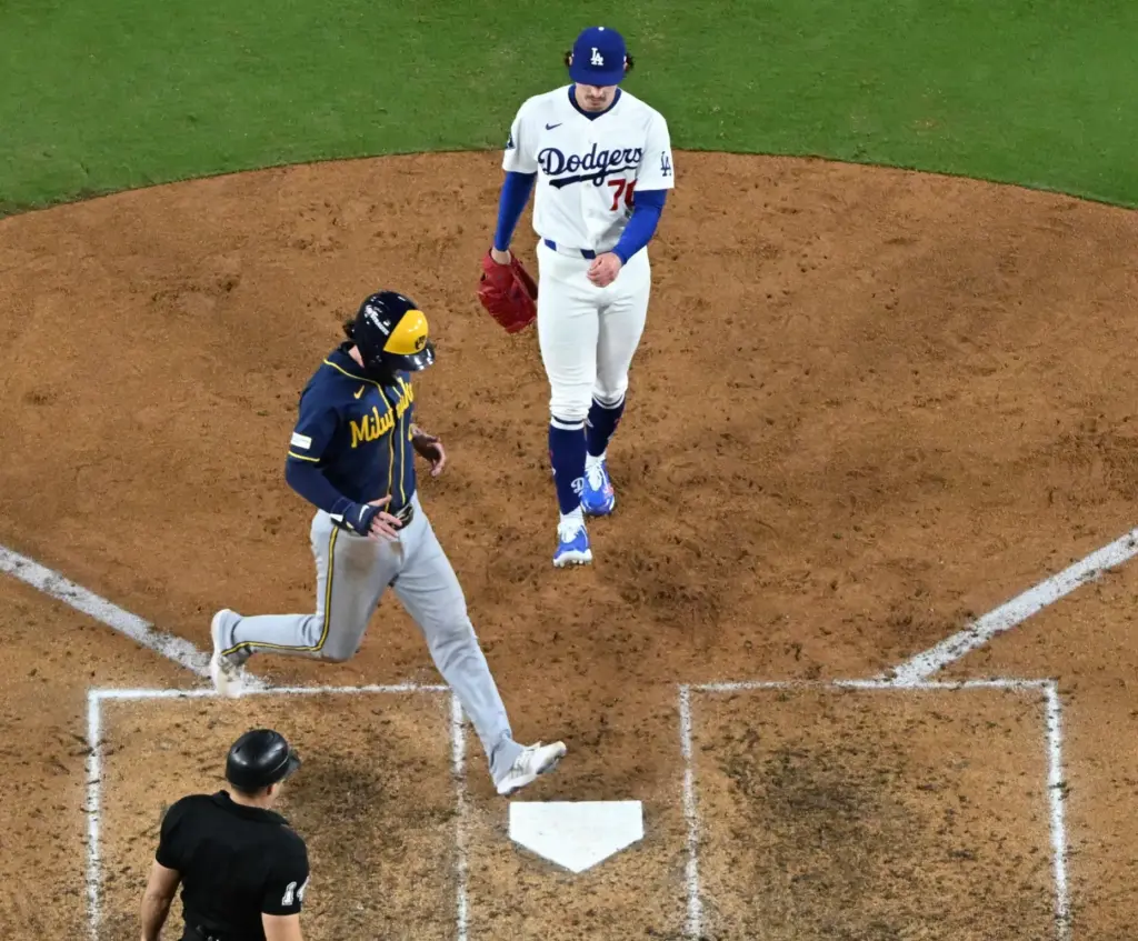 The Milwaukee Brewers’ Brice Turang, left, scores on a passed...