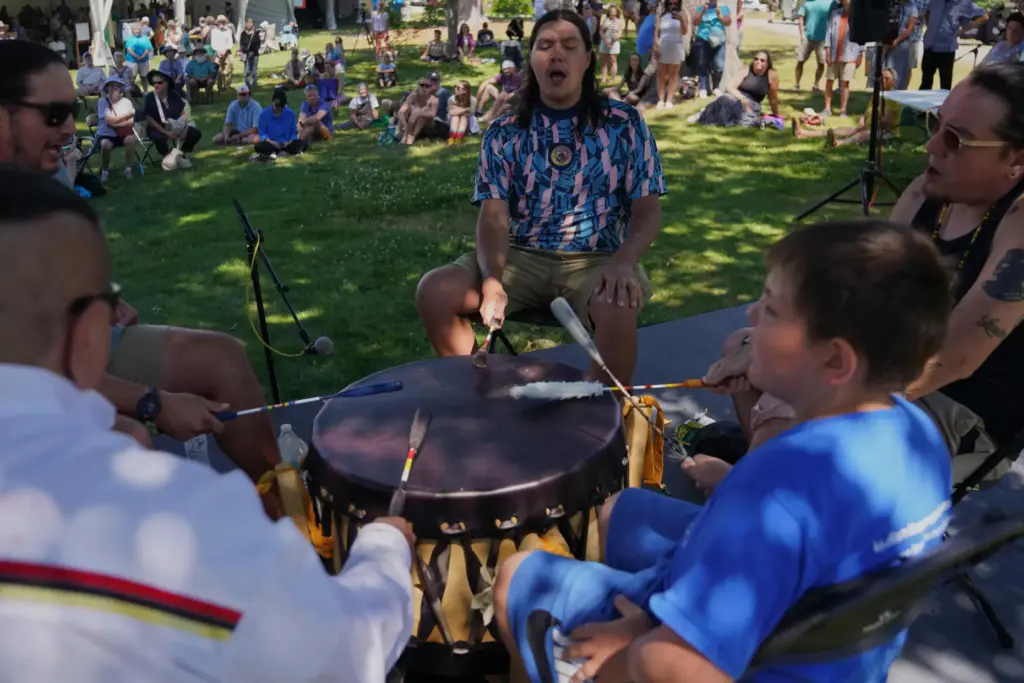 Members of a Penobscot drum circle perform at the Dawnland...