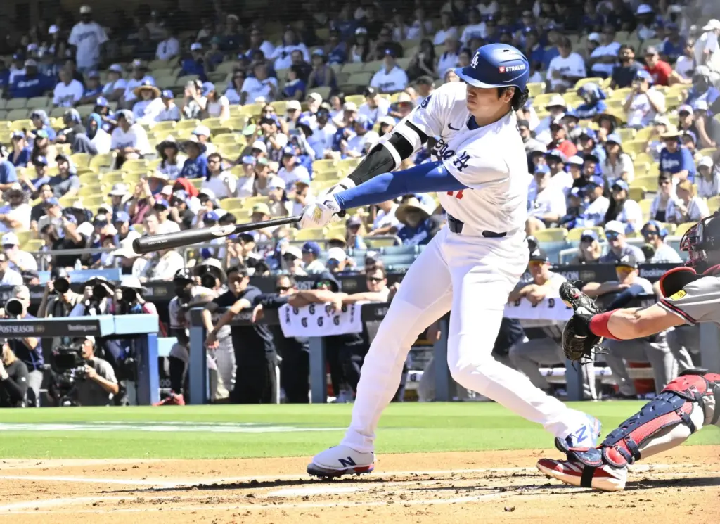 Dodgers star Shohei Ohtani hits a single during the first...