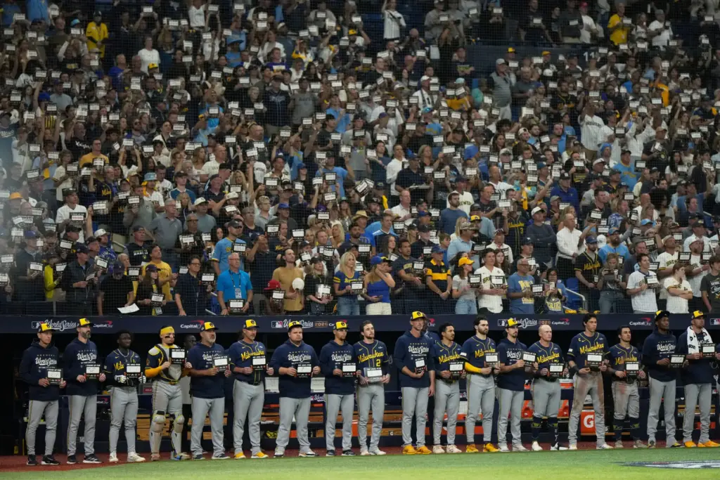 Members of the Milwaukee Brewers participate in the stand-up to...