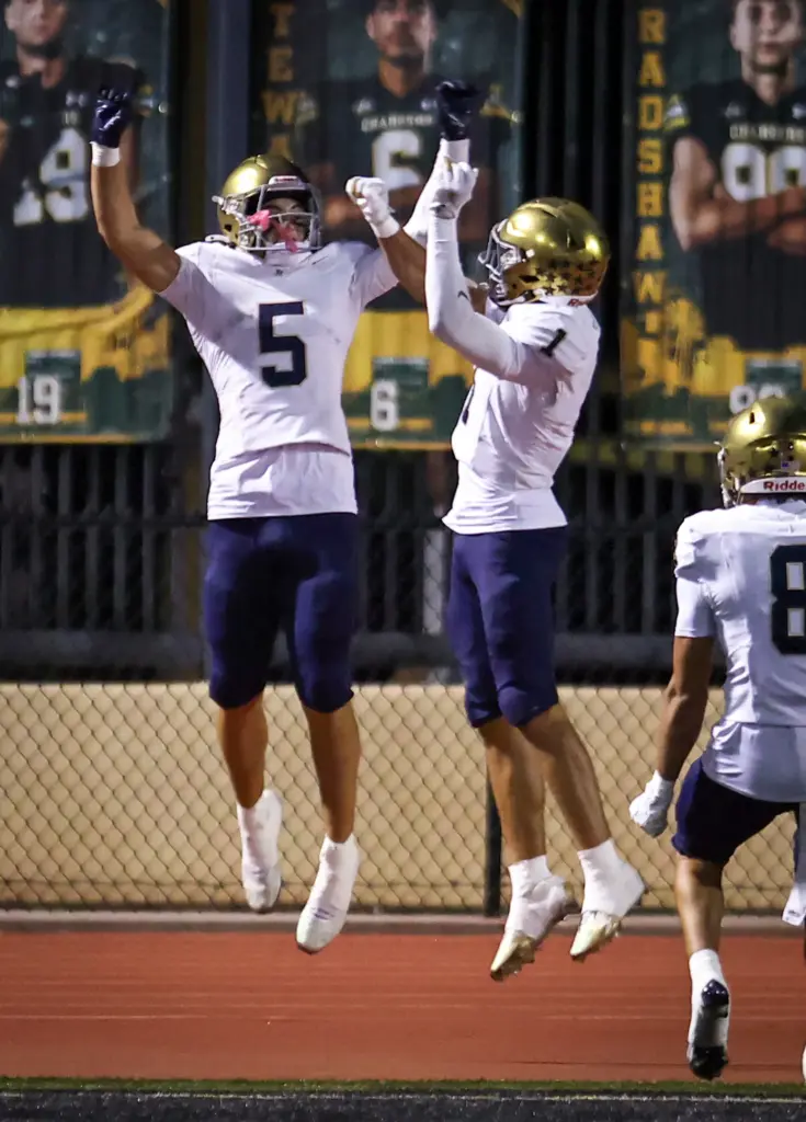 San Juan Hillsâ Luke Frith, left, celebrates a touchdown with...