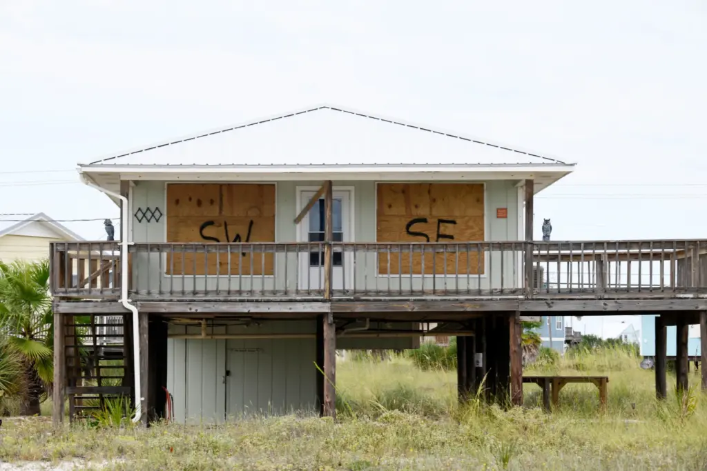A home is boarded up with plywood ahead of Hurricane...
