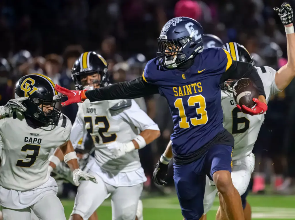 Crean Lutheran wide receiver Braylen Ross, right, pushes away Capistrano...