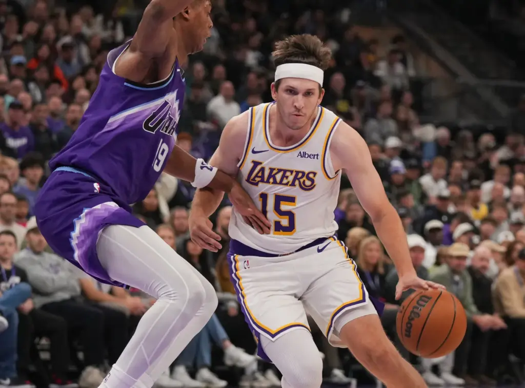 Lakers guard Austin Reaves (15) dribbles around Utah Jazz forward...