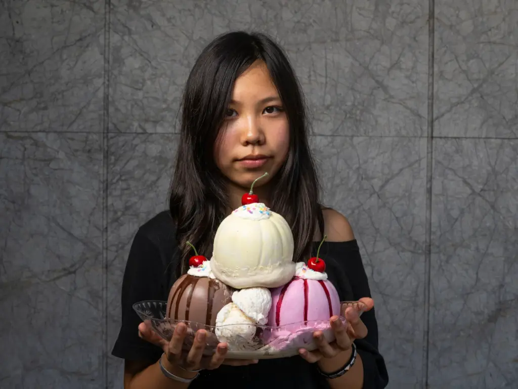 Mika Zhang holds her pumpkin titled âPumpkin Sundaeâ which she...