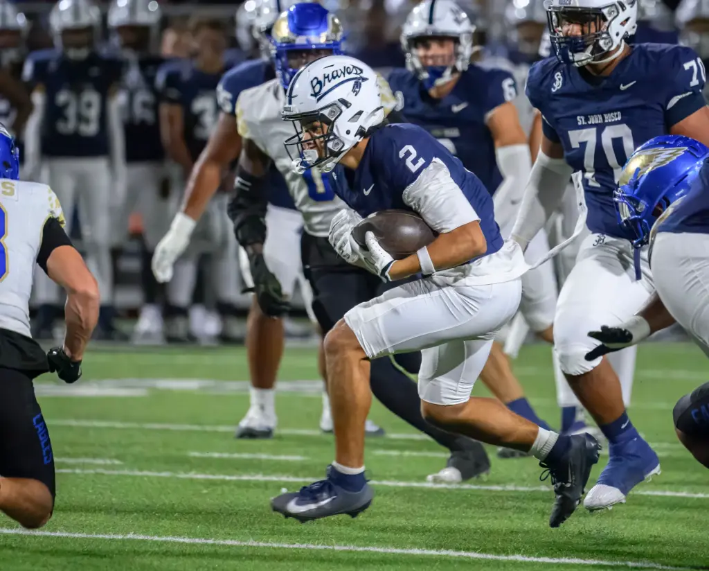 St. John Bosco wide receiver DJ Tubbs weaves his way...