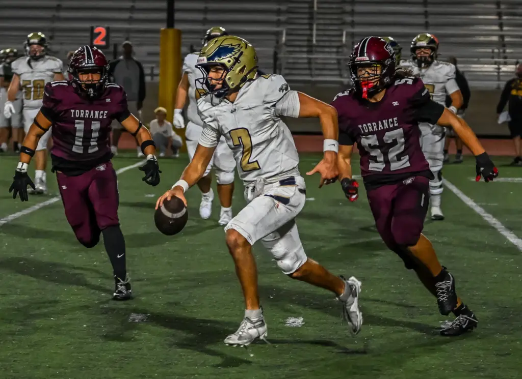 El Segundo quarterback Ryan Wiacek runs with the ball during...