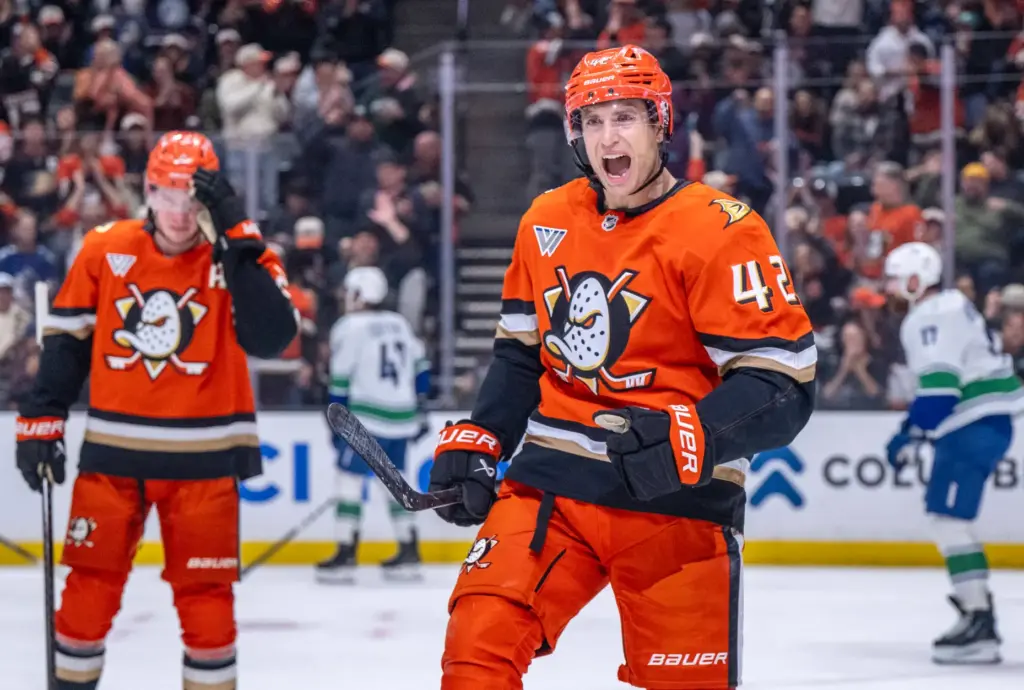 The Ducksâ Tim Washe, front, celebrates a goal by teammate...