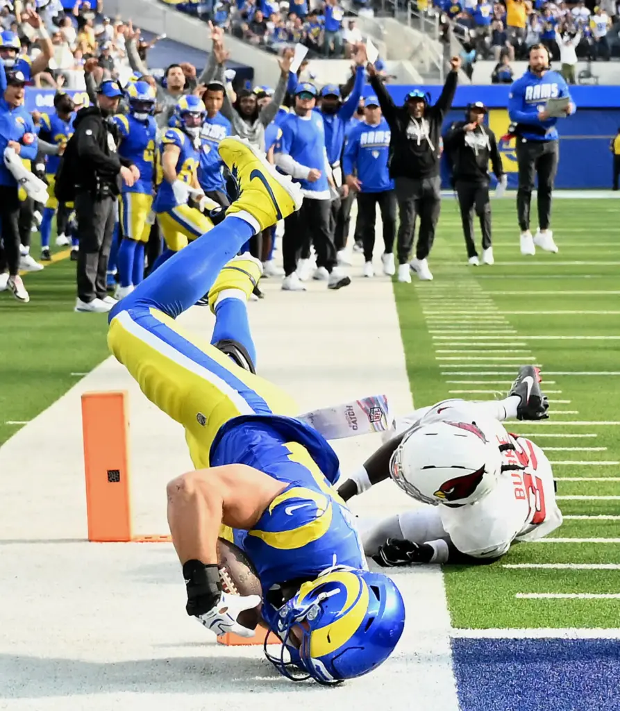 Rams tight end Colby Parkinson (84) rolls onto his head...