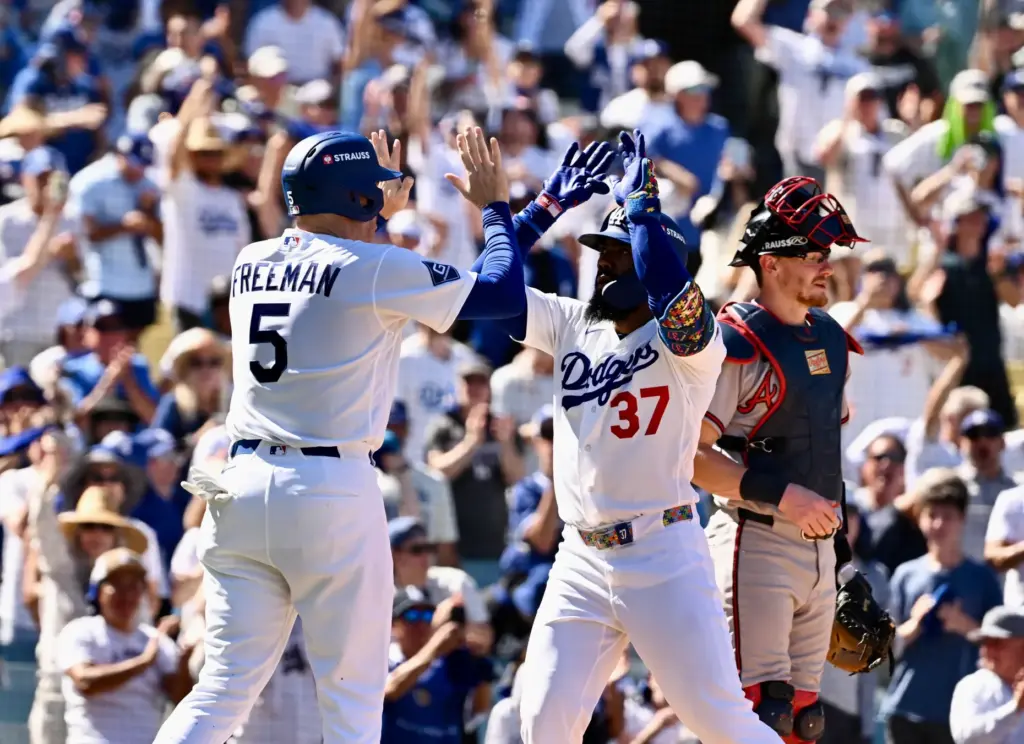 The Dodgers’ Teoscar HernÃ¡ndez, right, celebrates with teammate Freddie Freeman...