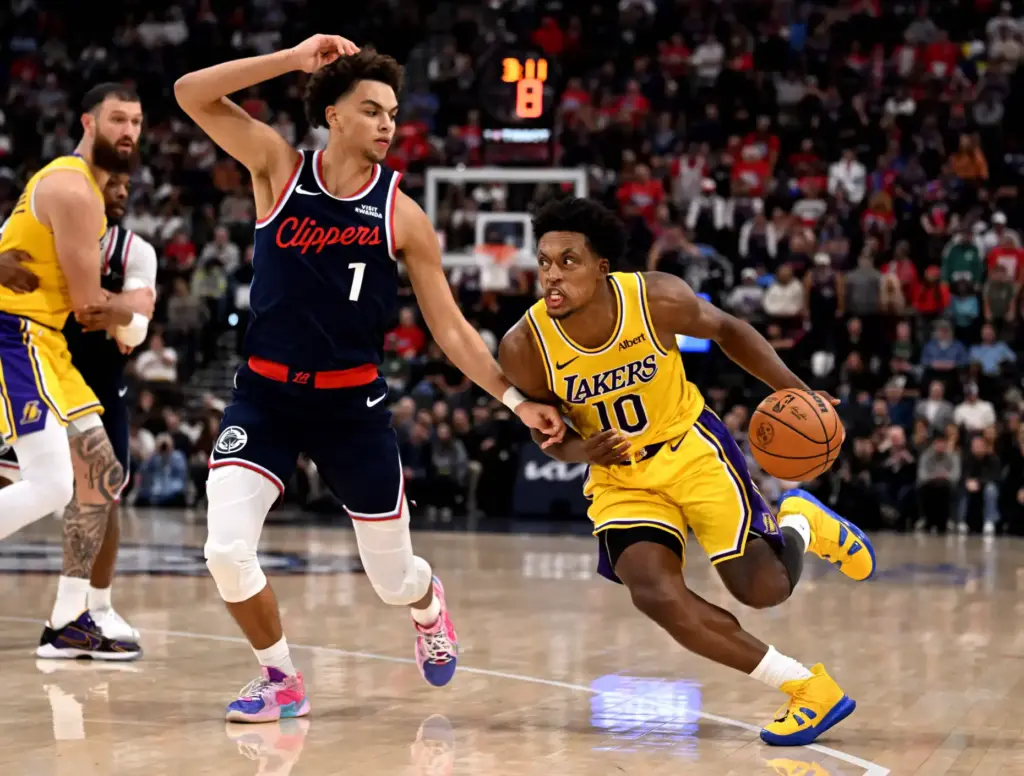 Lakers guard Collin Sexton drives to the basket as Clippers...