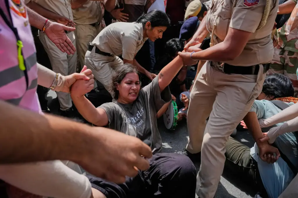 Socialist, left-wing parties and student activists shout slogans as police detain them.