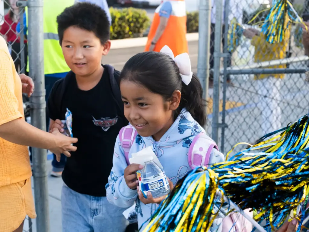 Students get snacks and water at Schmitt Elementary School in...