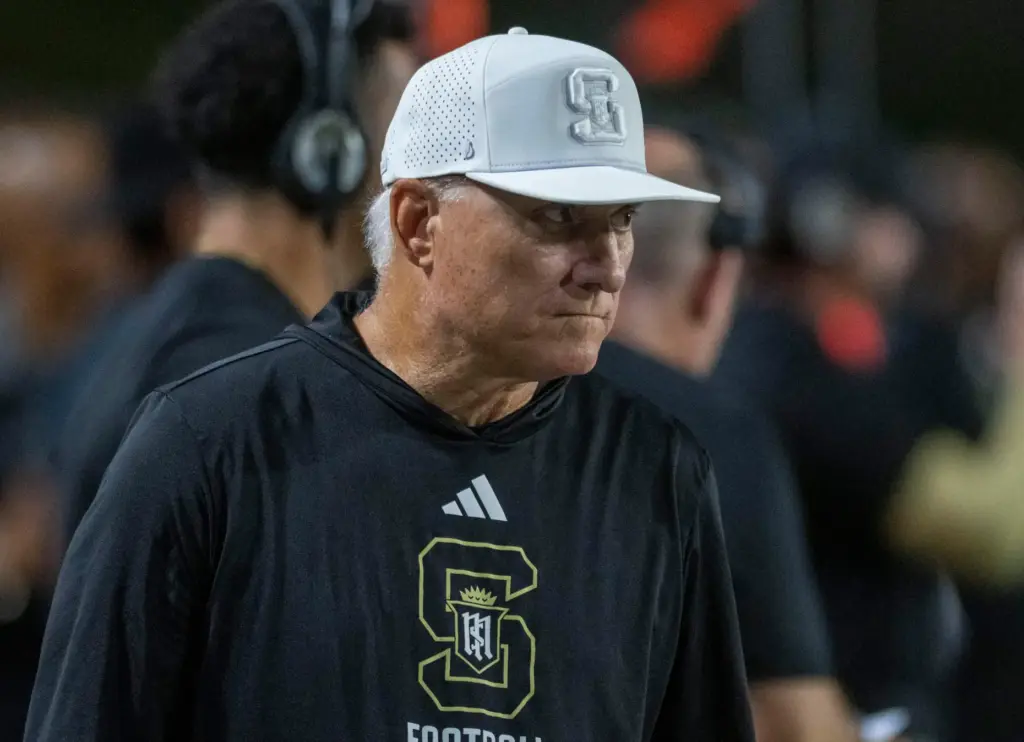 Rick Garretson, head football coach at Servite High walks the...