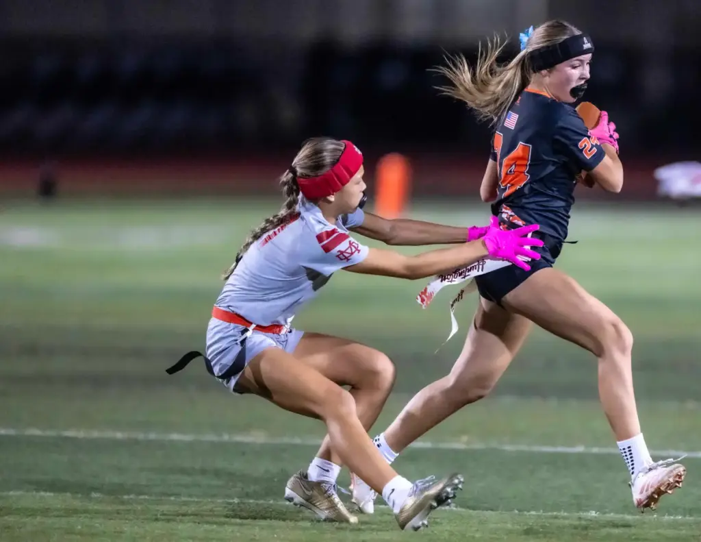 Huntington Beachâs Kayden Foley (24), right, carries the ball during...