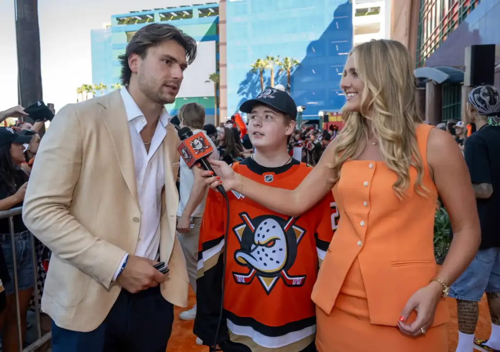 Ducks broadcaster Alexis Downie interviews Ducks player Cutter Gauthier, left,...