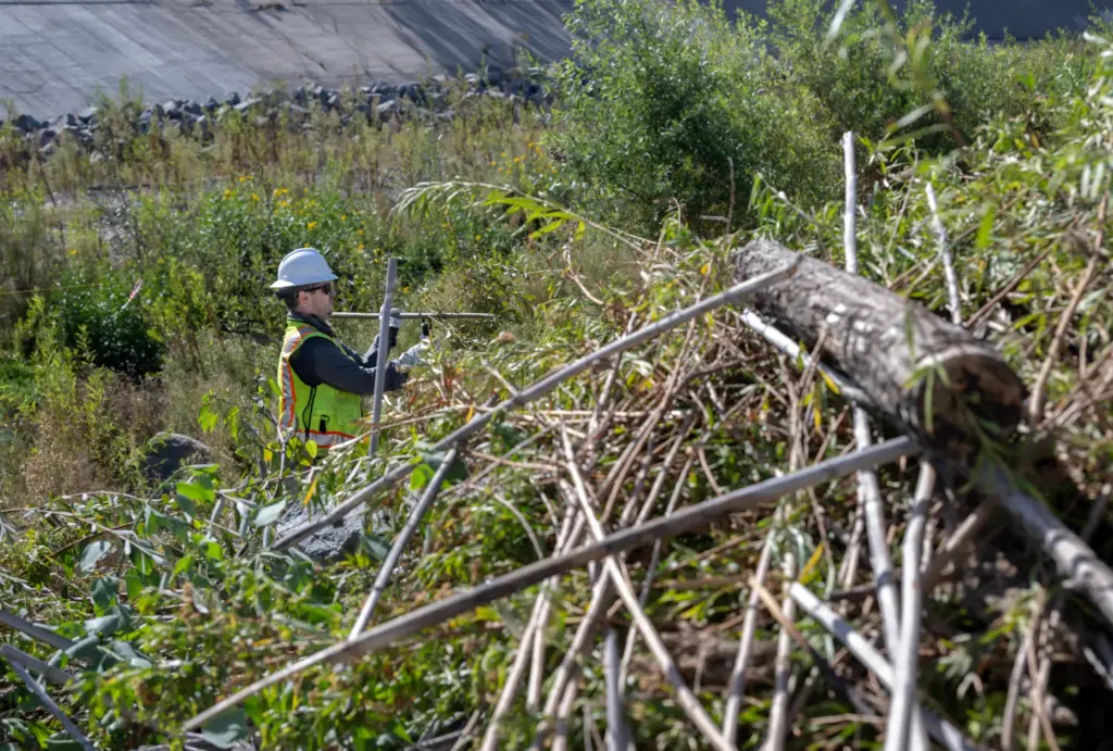 Workers clear the San Juan and Trabuco Creek flood control...