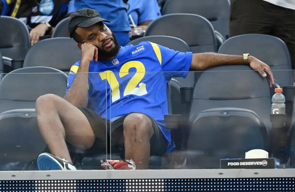 A Rams fan sits in disbelief after the Rams lost...