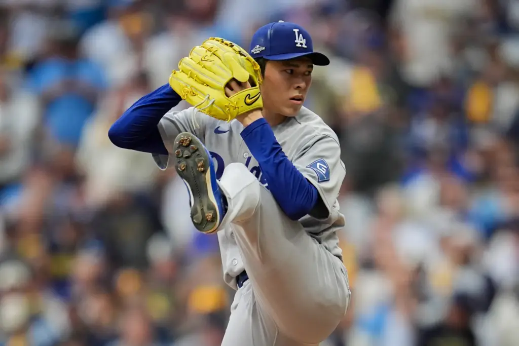 Dodgers relief pitcher Roki Sasaki throws to the plate during...