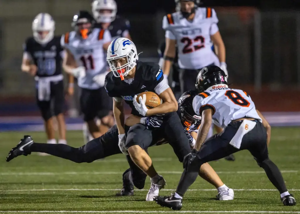 Huntington Beach wide receiver Jack Norman (6) carries the ball...