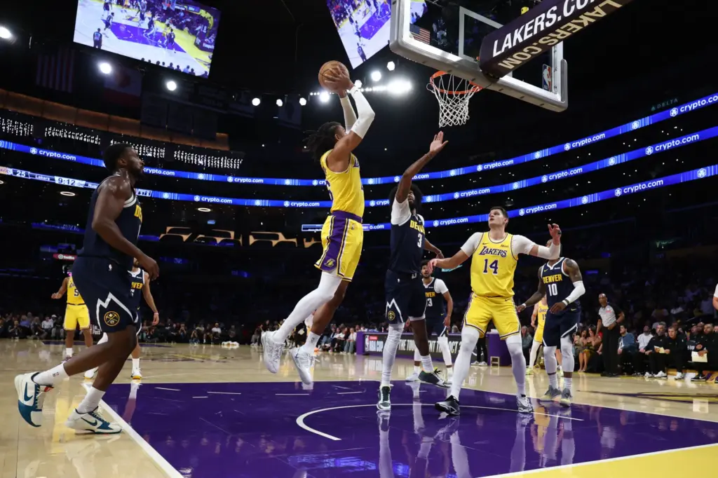 Lakers guard Matisse Thybulle, center, dunks during the first half...