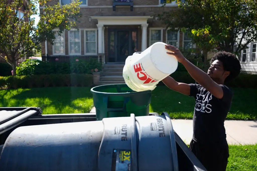 Ricky Blanding, founder of Scrap Soils, collects compostable material Monday,...