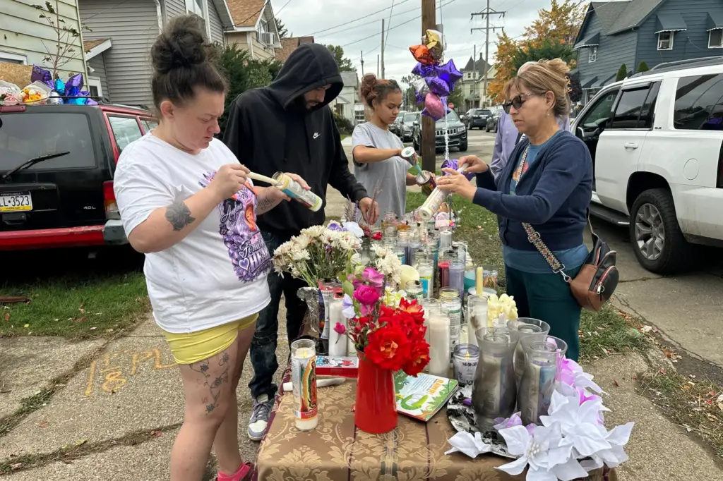 People gather at a memorial in Erie, Pennsylvania, after a shooting.