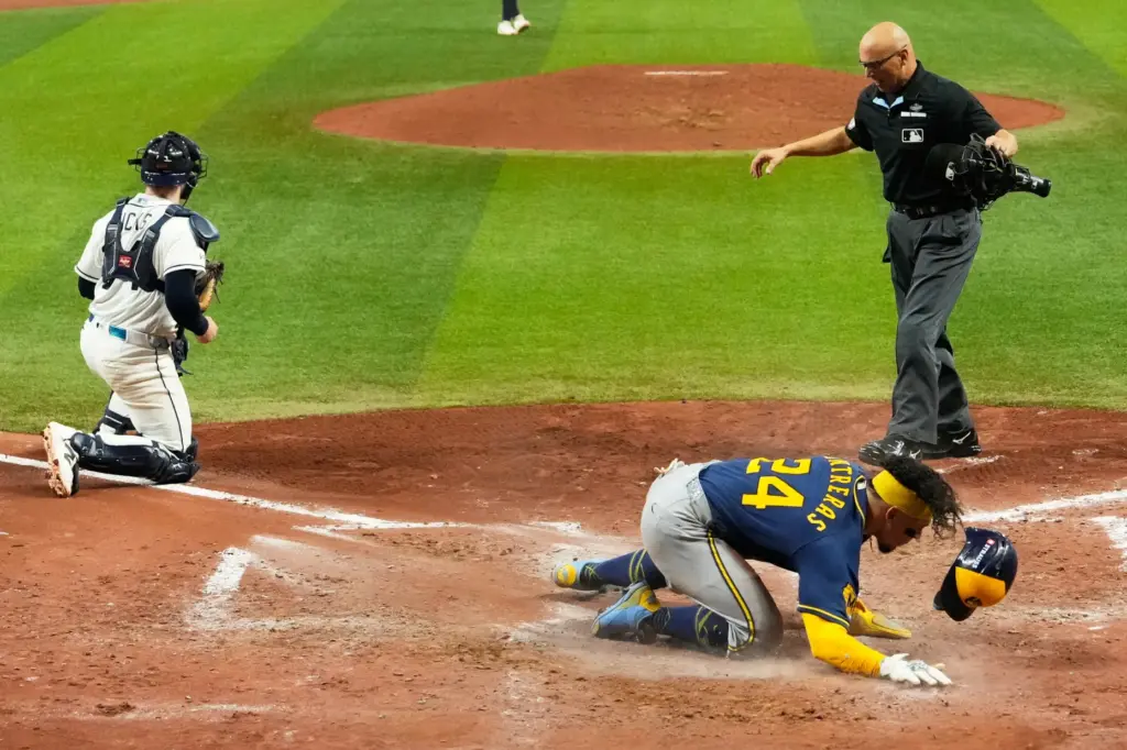 The Milwaukee Brewers’ William Contreras celebrates after scoring during the...