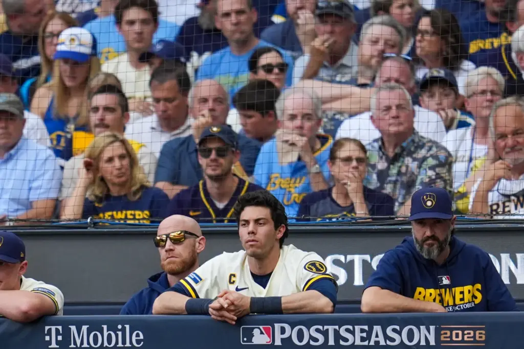 Milwaukee Brewers designated hitter Christian Yelich watches from the dugout...