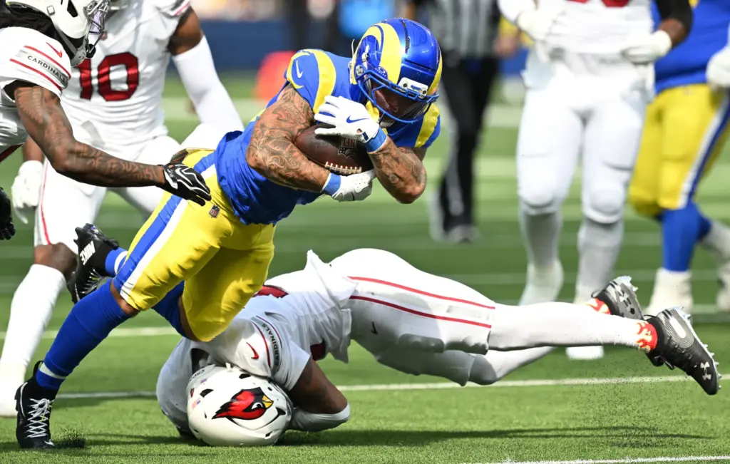 Rams running back Blake Corum (24) is taken down by...