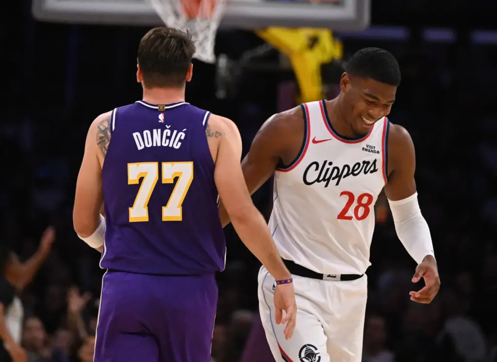 Lakers star Luka Doncic, left, gets a smile from Clippers...