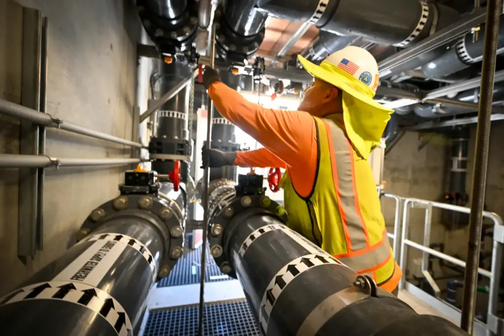 Carlos Chavira works on the new water system at at...