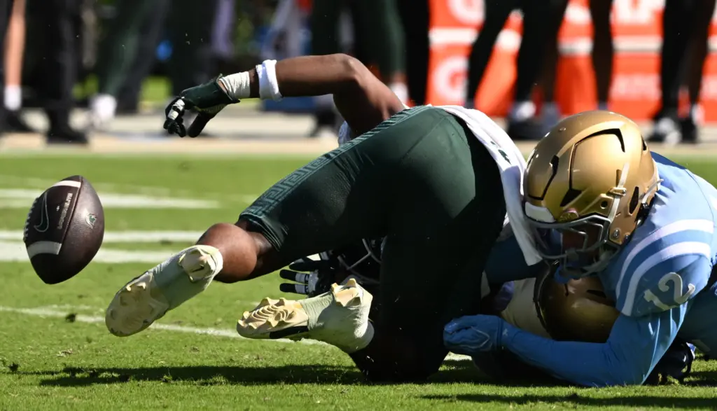Michigan State running back Kenneth Williams (32) fumbles the ball,...